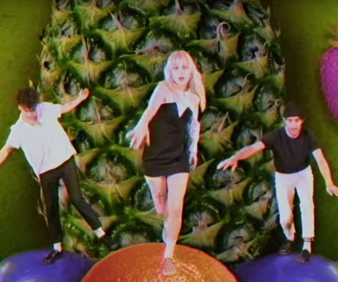 Paramore Run On Giant Fruit In Their New Video For 'Caught In The Middle'